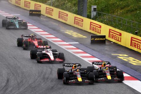 (L to R): Max Verstappen (NLD) Red Bull Racing RB19 and team mate Sergio Perez (MEX) Red Bull Racing RB19 battle for the