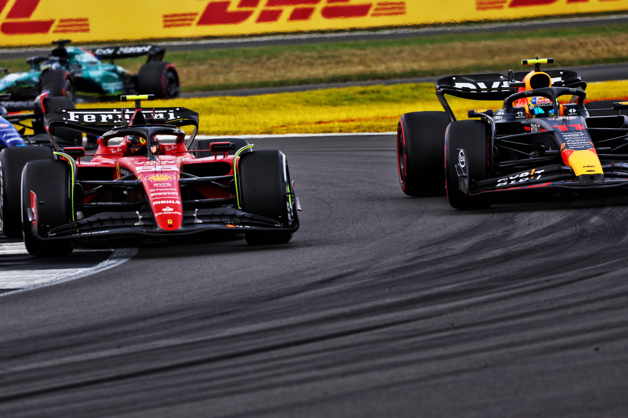 Carlos Sainz Jr (ESP) Ferrari SF-23 and Sergio Perez (MEX) Red Bull Racing RB19 battle for position. Formula 1 World